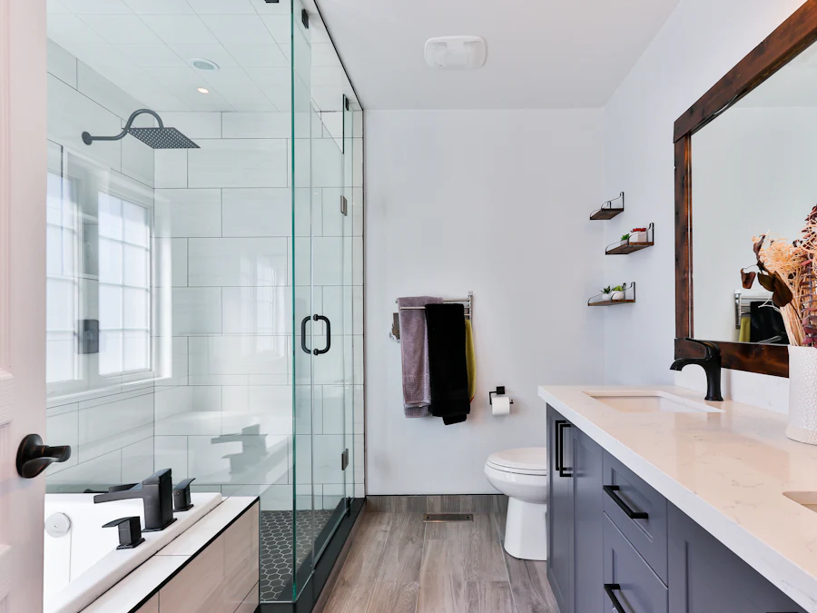 Bright modern bathroom with a glass walk-in shower, wood-effect floor and double vanity